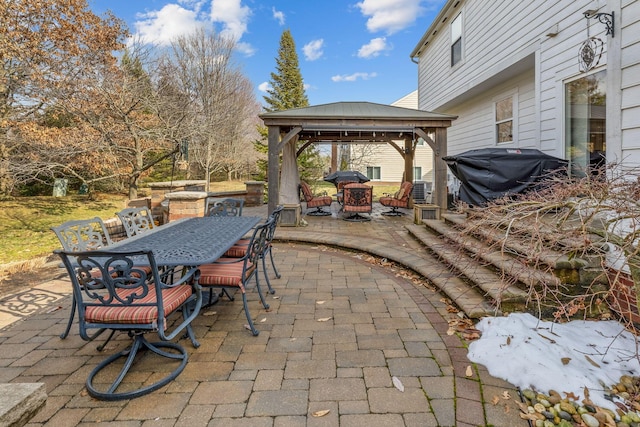 view of patio with an outdoor fire pit, a grill, outdoor dining area, and a gazebo