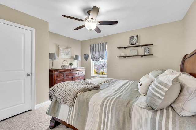 carpeted bedroom featuring ceiling fan and baseboards