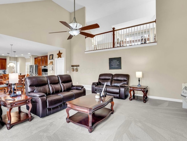 living room with recessed lighting, light colored carpet, a ceiling fan, high vaulted ceiling, and baseboards