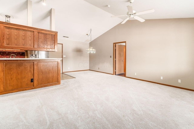 unfurnished living room featuring sink, ceiling fan, light carpet, and lofted ceiling