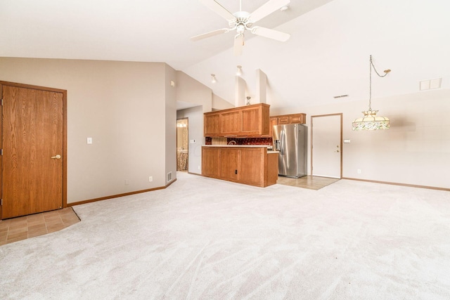 unfurnished living room with ceiling fan, light carpet, and lofted ceiling