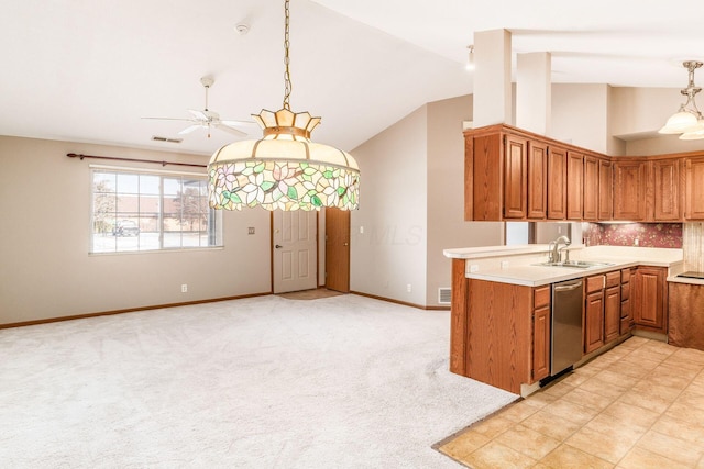 kitchen with decorative light fixtures, light carpet, sink, vaulted ceiling, and stainless steel dishwasher