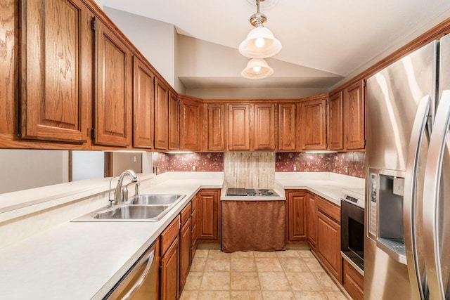 kitchen with sink, stainless steel appliances, vaulted ceiling, and decorative light fixtures