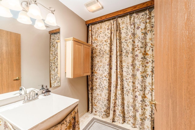 bathroom featuring sink, tile patterned floors, and an inviting chandelier