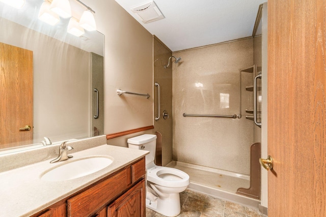 bathroom with vanity, toilet, and walk in shower