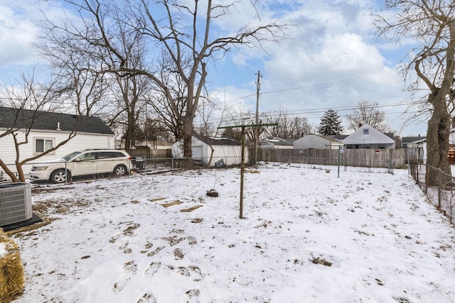 yard covered in snow featuring central AC unit