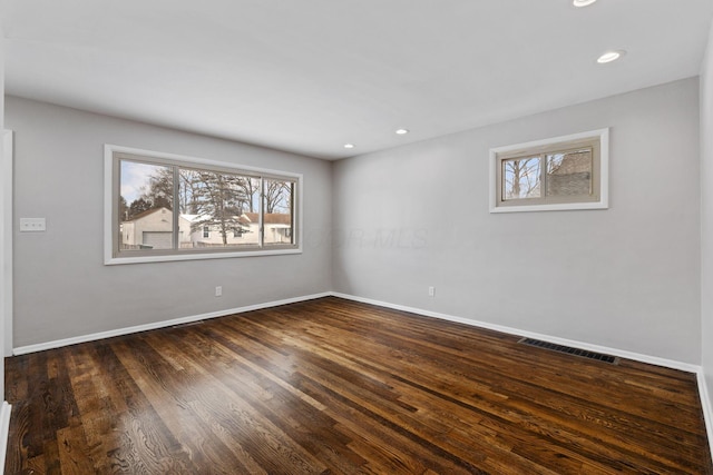 spare room with dark hardwood / wood-style flooring