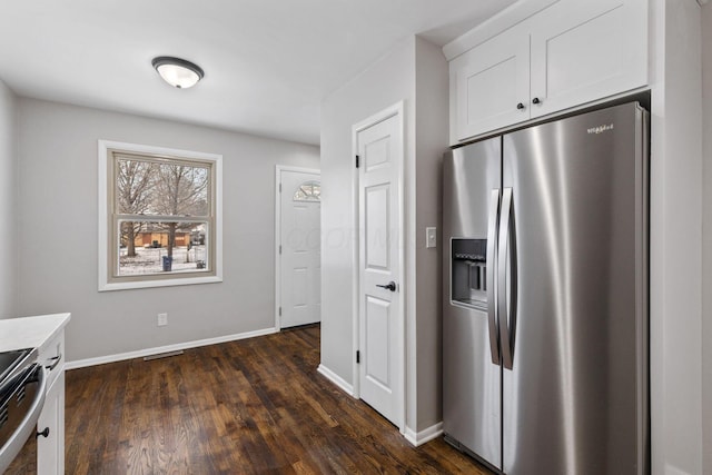 kitchen with white cabinetry, stainless steel appliances, and dark hardwood / wood-style flooring