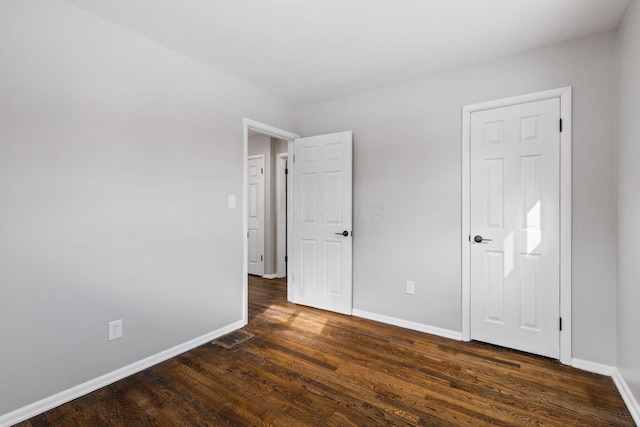 spare room featuring dark wood-type flooring