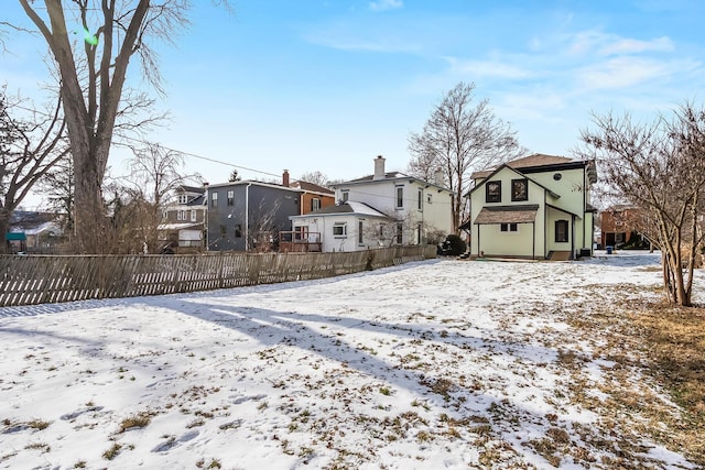 view of snow covered rear of property