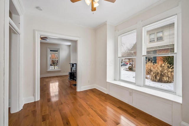 spare room featuring ceiling fan, hardwood / wood-style floors, and crown molding