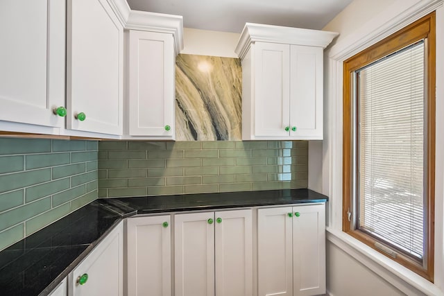 kitchen featuring white cabinets and dark stone countertops