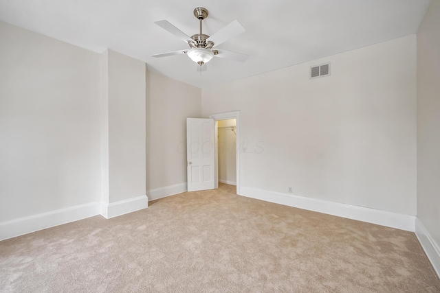 spare room featuring ceiling fan and carpet