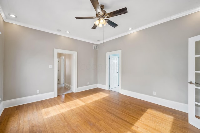 spare room featuring crown molding, hardwood / wood-style floors, and ceiling fan