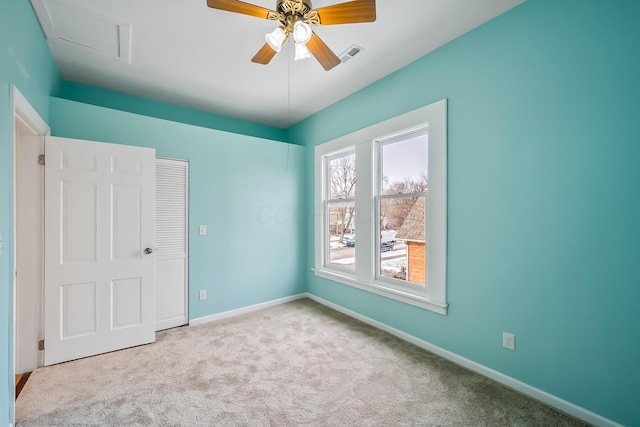 spare room featuring ceiling fan and light carpet