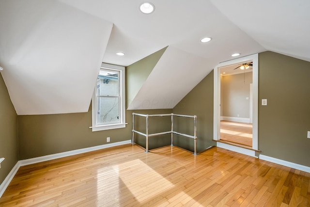 bonus room with light hardwood / wood-style floors and vaulted ceiling