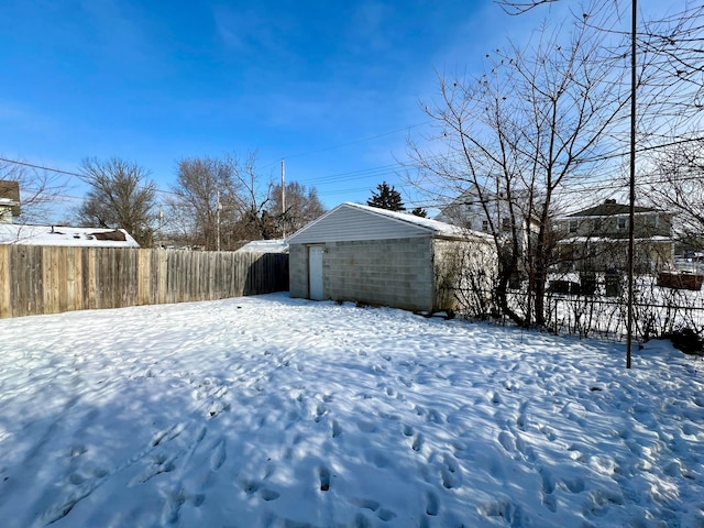 yard covered in snow featuring an outdoor structure