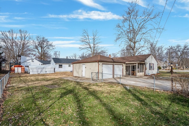 back of house featuring a garage, a patio area, and a lawn