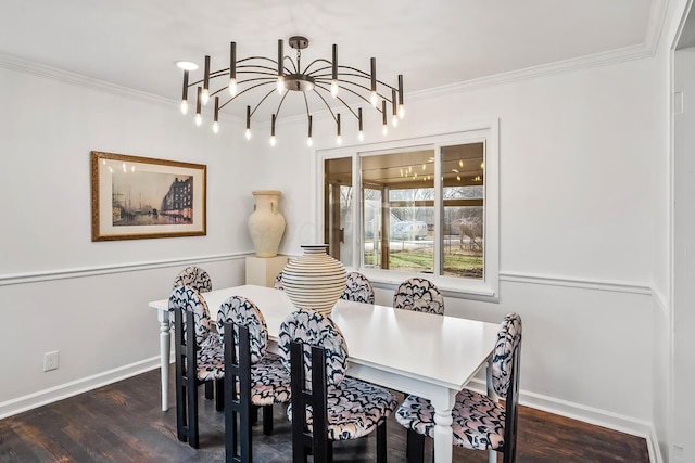 dining room featuring dark hardwood / wood-style flooring, ornamental molding, and a chandelier