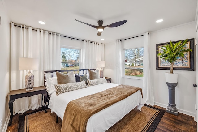 bedroom featuring multiple windows, dark hardwood / wood-style flooring, and ceiling fan