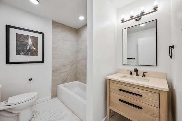 full bathroom with tile patterned flooring, vanity, tiled shower / bath, and toilet