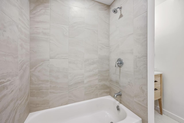 bathroom featuring vanity and tiled shower / bath combo