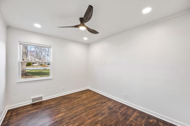 empty room with dark hardwood / wood-style flooring, crown molding, and ceiling fan