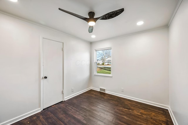 spare room with dark hardwood / wood-style flooring, crown molding, and ceiling fan