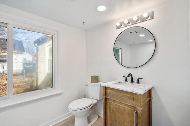 bathroom featuring vanity and toilet