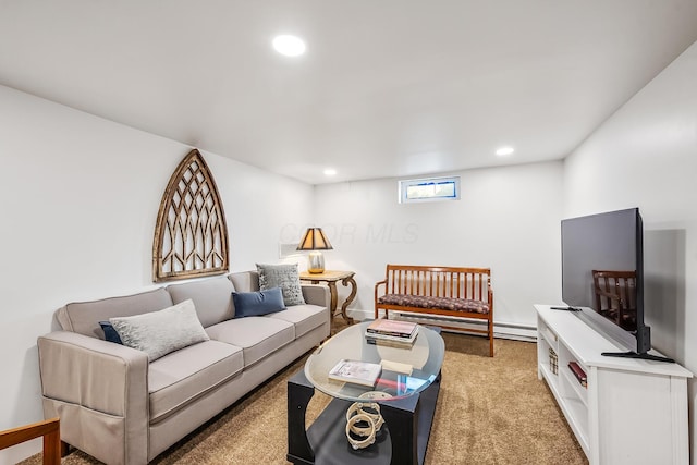 living room with a baseboard heating unit and light colored carpet