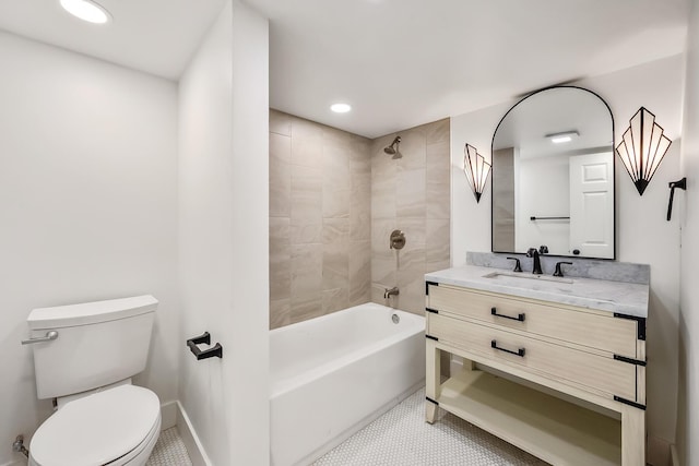 full bathroom featuring vanity, tiled shower / bath combo, and toilet