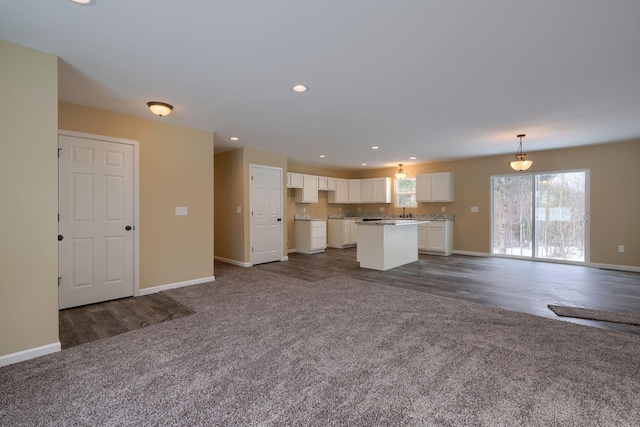 unfurnished living room featuring dark carpet