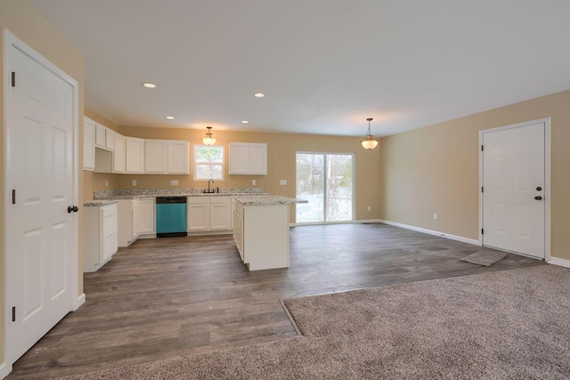 kitchen featuring dishwasher, white cabinetry, hanging light fixtures, sink, and a kitchen island