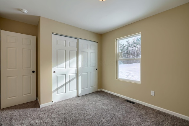 unfurnished bedroom featuring carpet floors and a closet