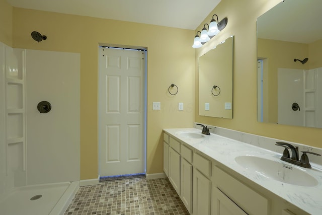 bathroom featuring a shower and vanity