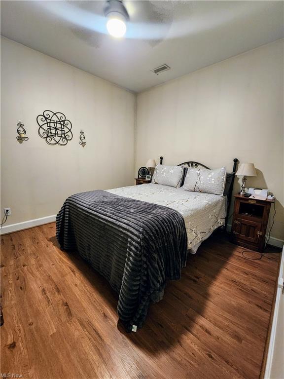 bedroom featuring wood-type flooring and ceiling fan