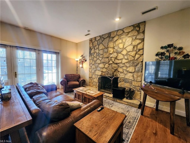 living room featuring dark wood-type flooring and a fireplace