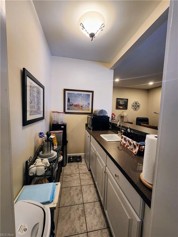 interior space featuring tile patterned flooring and sink