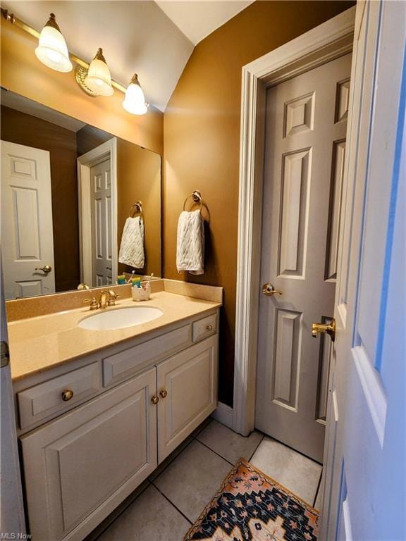 bathroom featuring tile patterned flooring and vanity