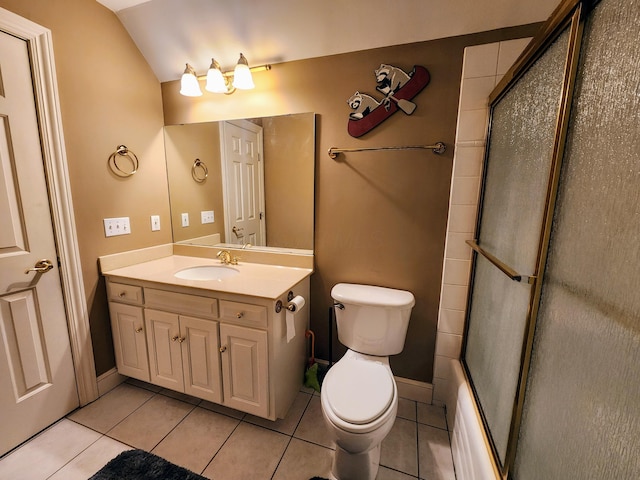 full bathroom with combined bath / shower with glass door, vanity, vaulted ceiling, tile patterned floors, and toilet