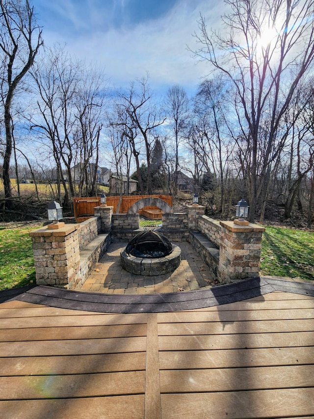 wooden terrace featuring an outdoor fire pit