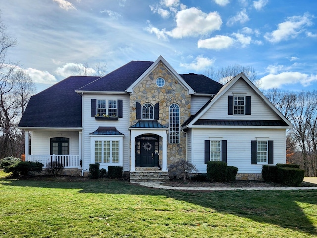 view of front of home with covered porch and a front yard