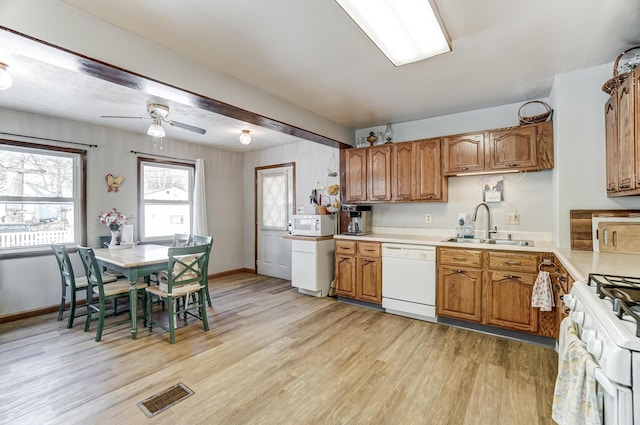 kitchen featuring sink, white appliances, ceiling fan, and light hardwood / wood-style floors