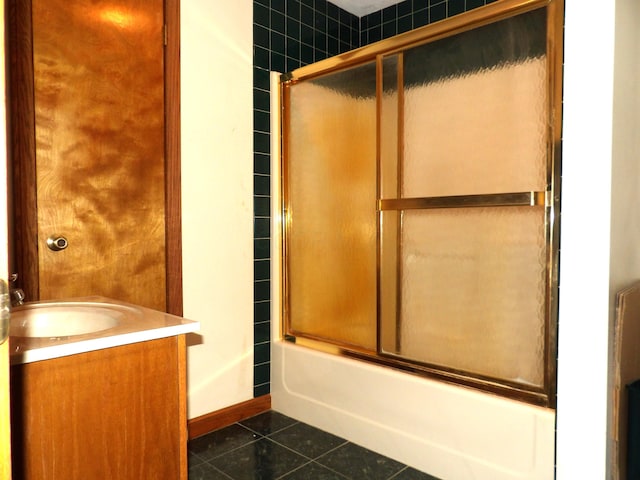 bathroom featuring vanity, shower / bath combination with glass door, and tile patterned floors