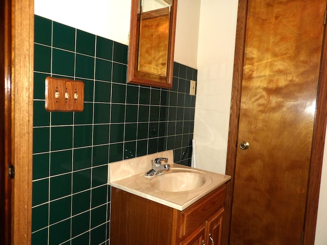 bathroom with vanity and tile walls