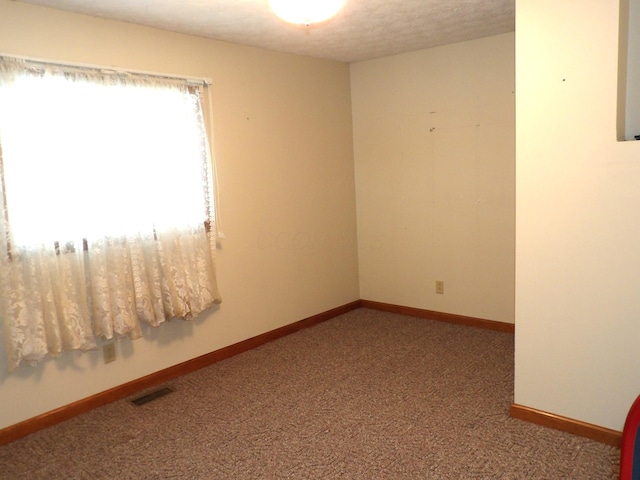 unfurnished room featuring carpet flooring