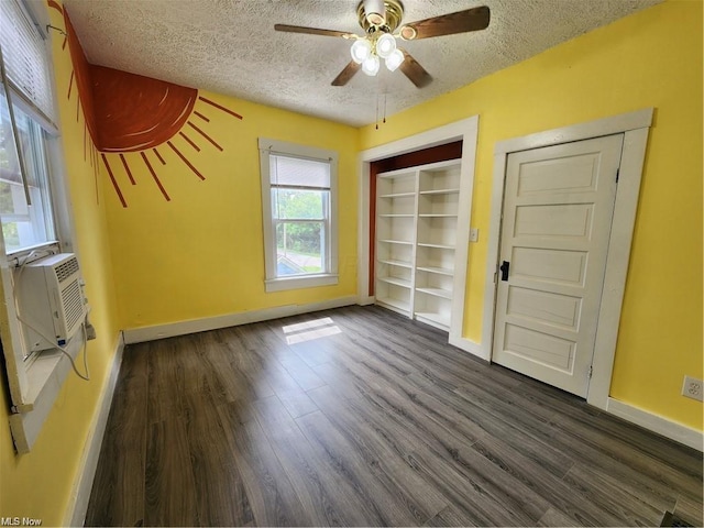 interior space with ceiling fan, dark wood-type flooring, and a textured ceiling