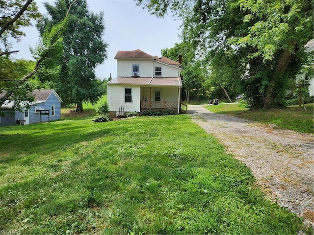 view of front of home with a front yard and covered porch