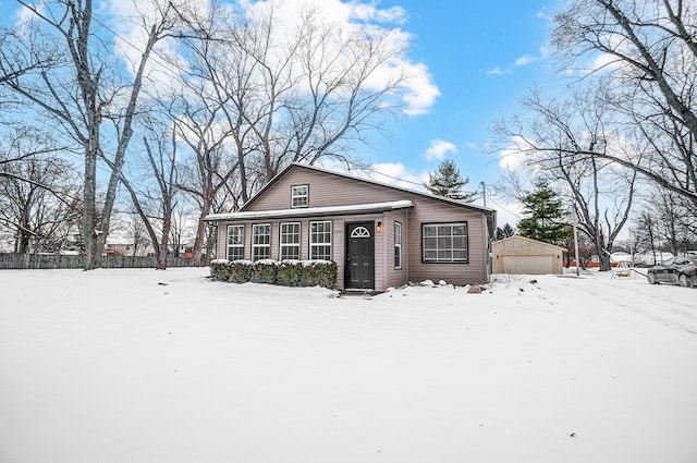 view of front of property featuring an outdoor structure and a garage