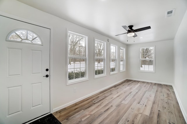 foyer with ceiling fan and light hardwood / wood-style floors